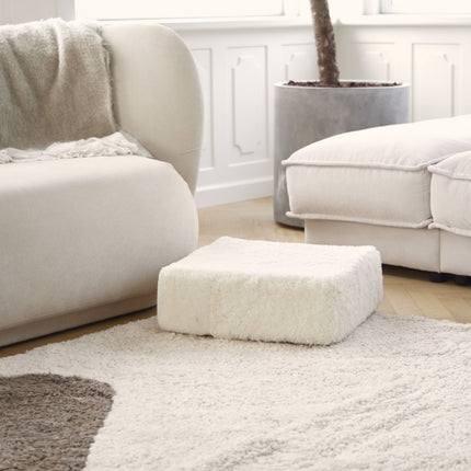 Kort, krøllete saueskinnspuff i ull Koksgrå